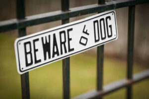 Beware of Dog Sign hanging on fence Dog Bite Lawyer Marietta GA